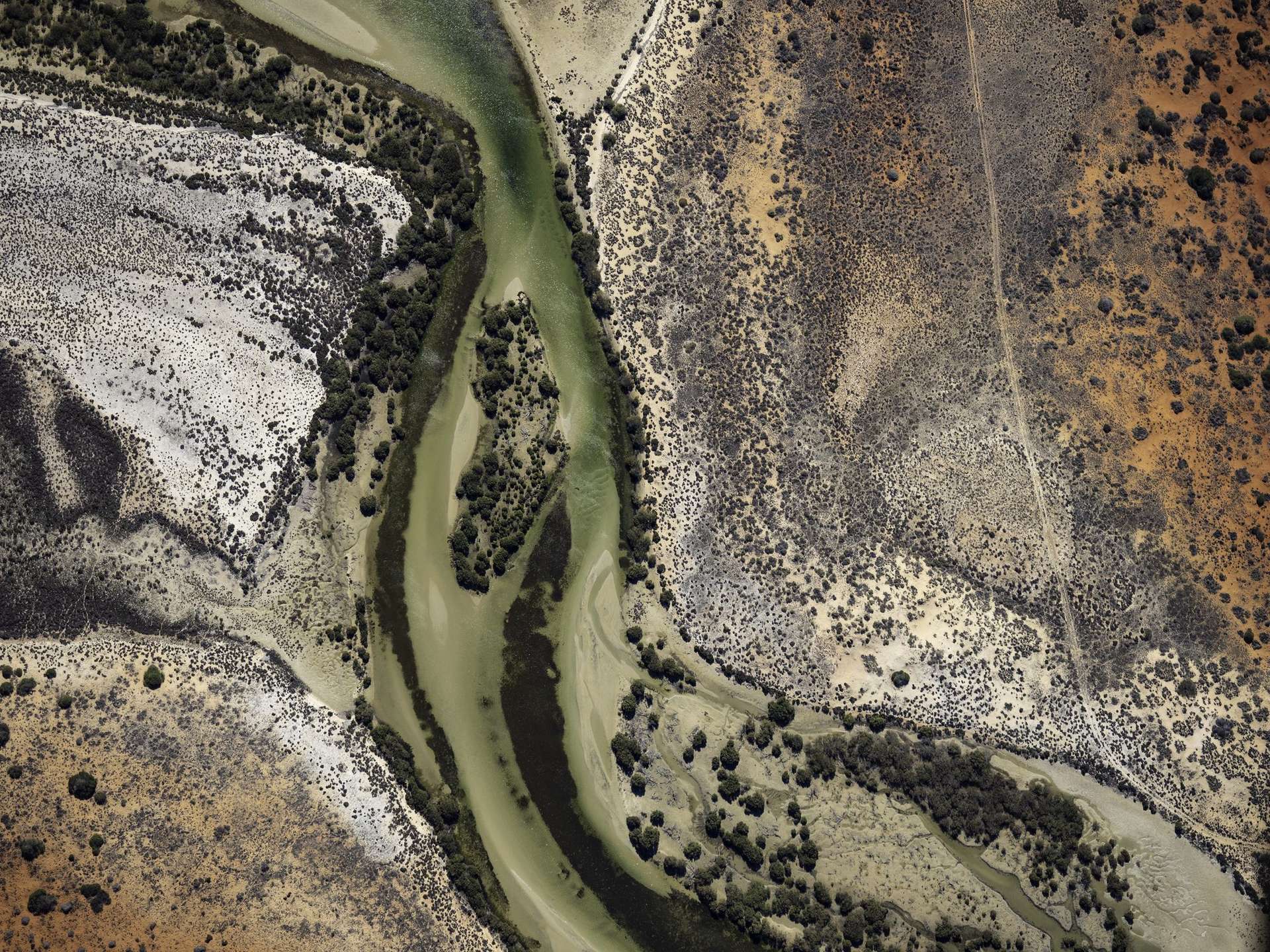Aerial view of a river winding through the red Australian outback